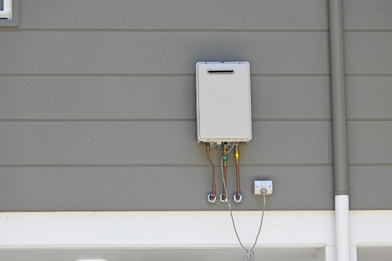 A hot water sytem placed on a residential house.