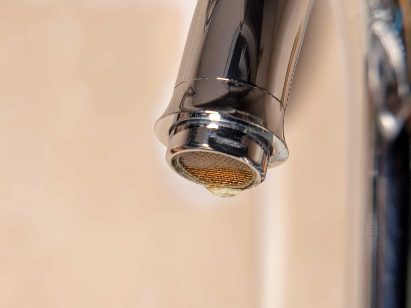 Drop of water leaking from mixer tap