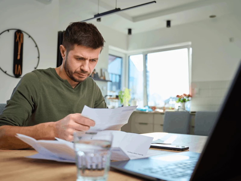 Man looking his water bill in awe