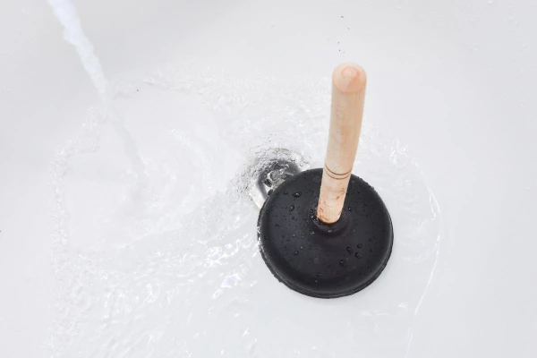 blocked bath drain and a plunger