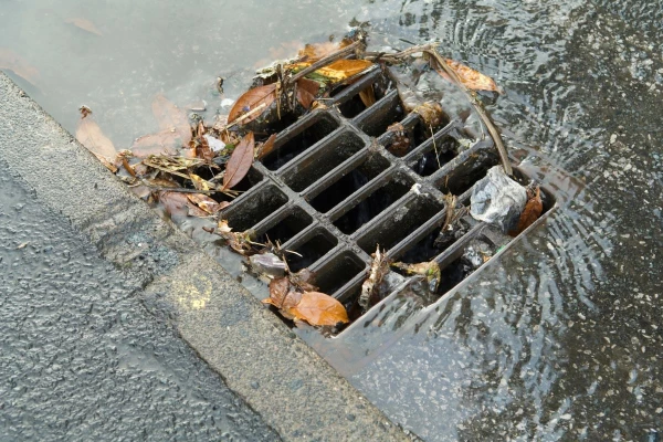 A blocked stormwater drain on an Australian street.