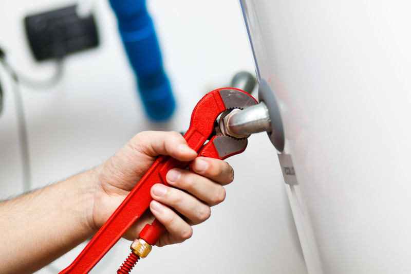 A perth plumber fixing a broken electric hot water system