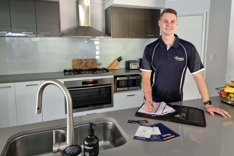Michael Swan from Swan's Professional Plumbing fixing a leaking tap