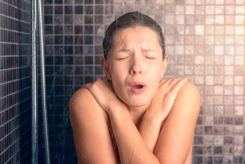 A person showering with a broken hot water system