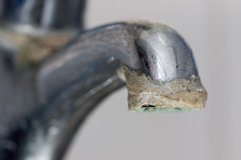 a tap with hard water build up forming
