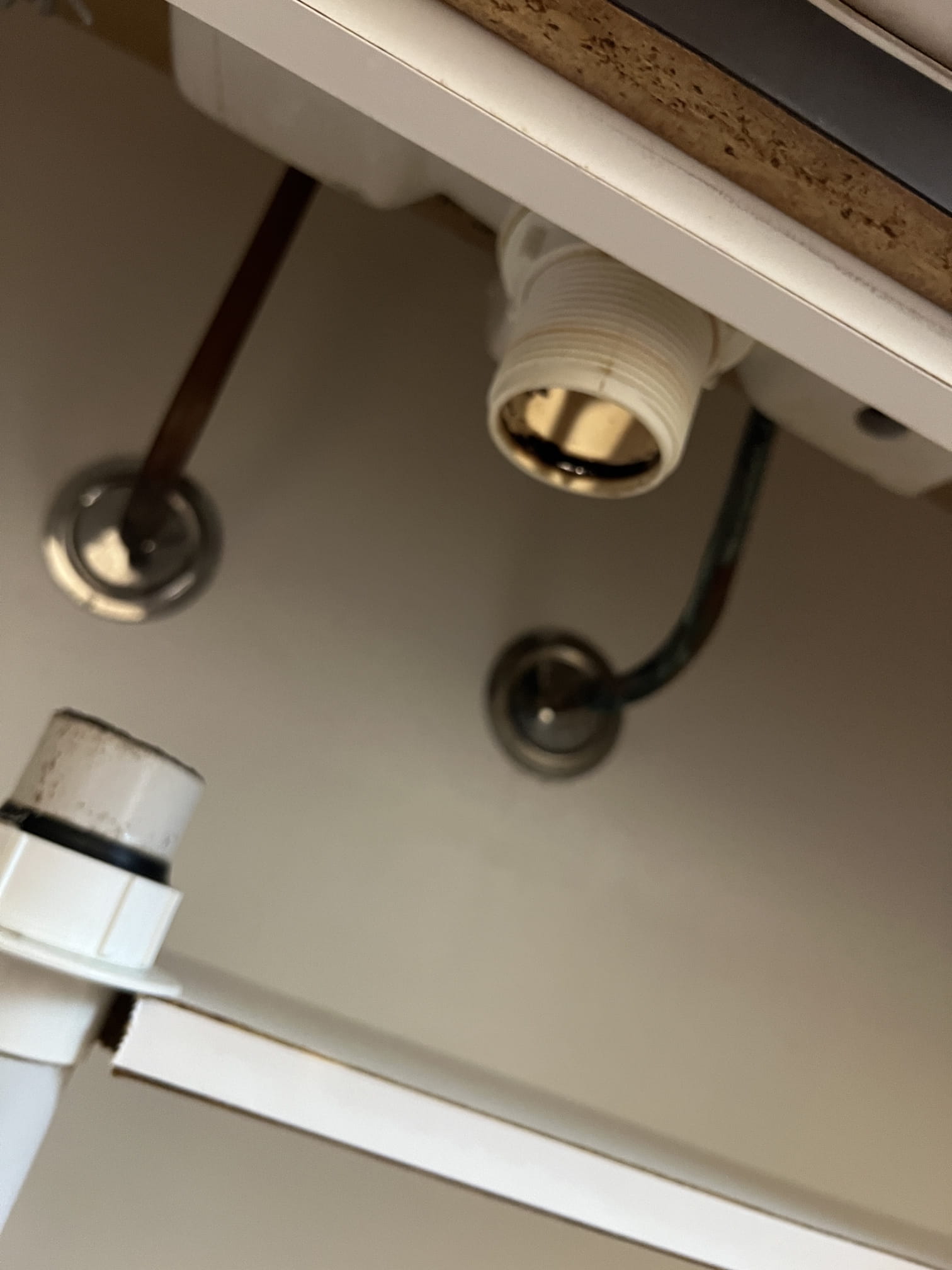 Pipework under a bathroom vanity before repairs in Baldivis