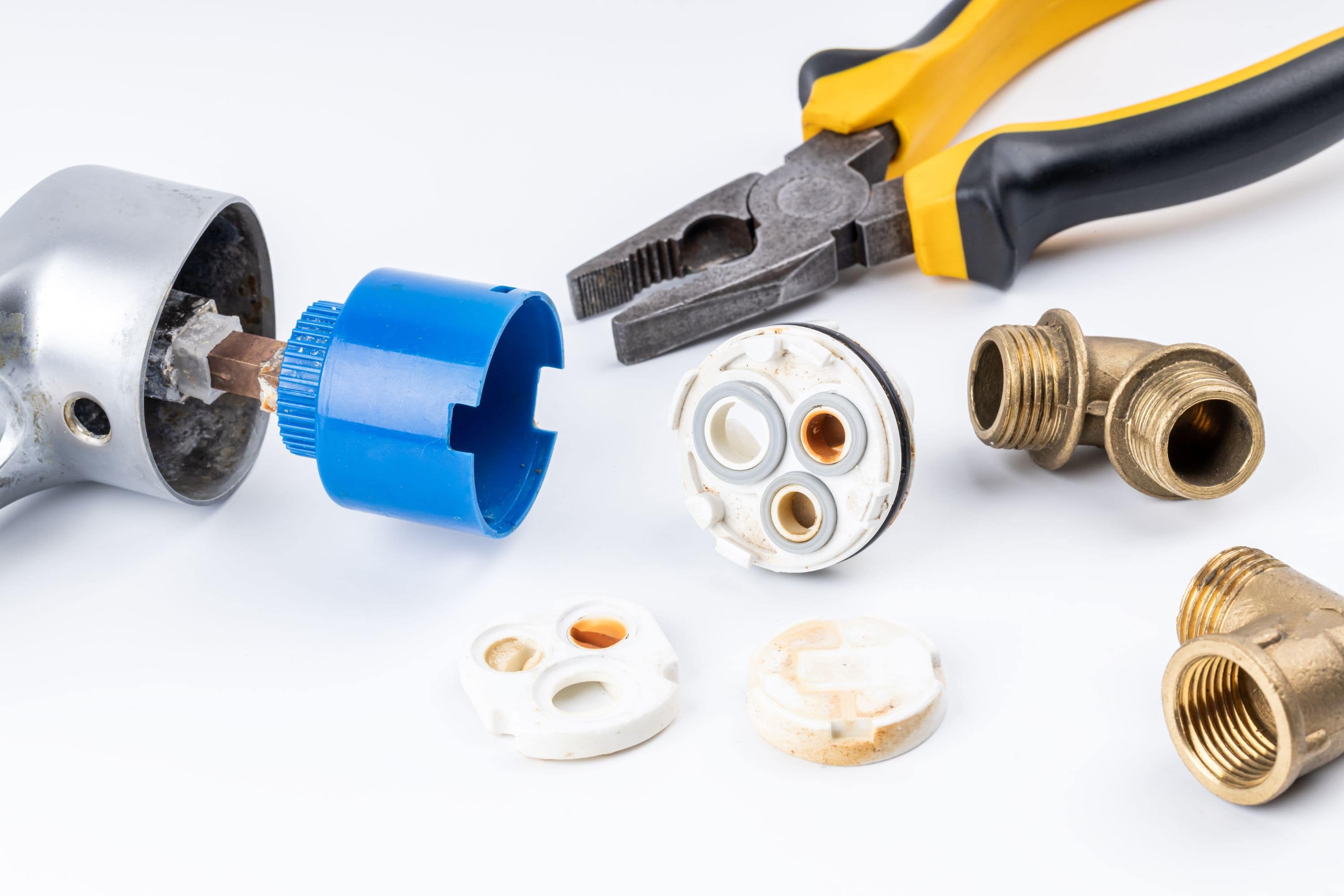 a person inspecting the washers and cartridges on a leaking tap